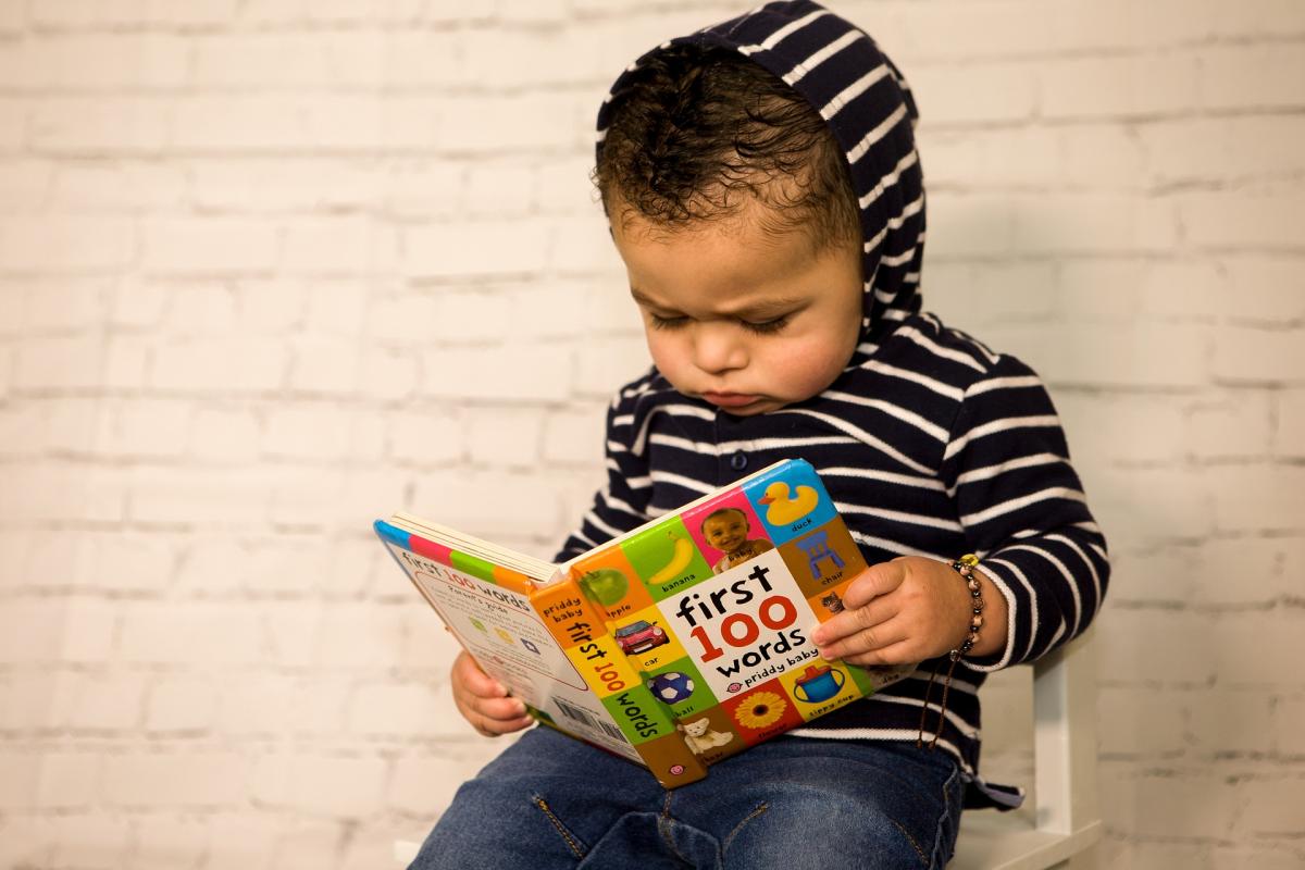 toddler holding book