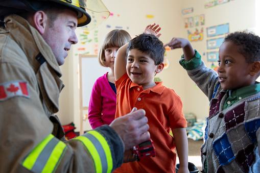 firefighter talking to a boy